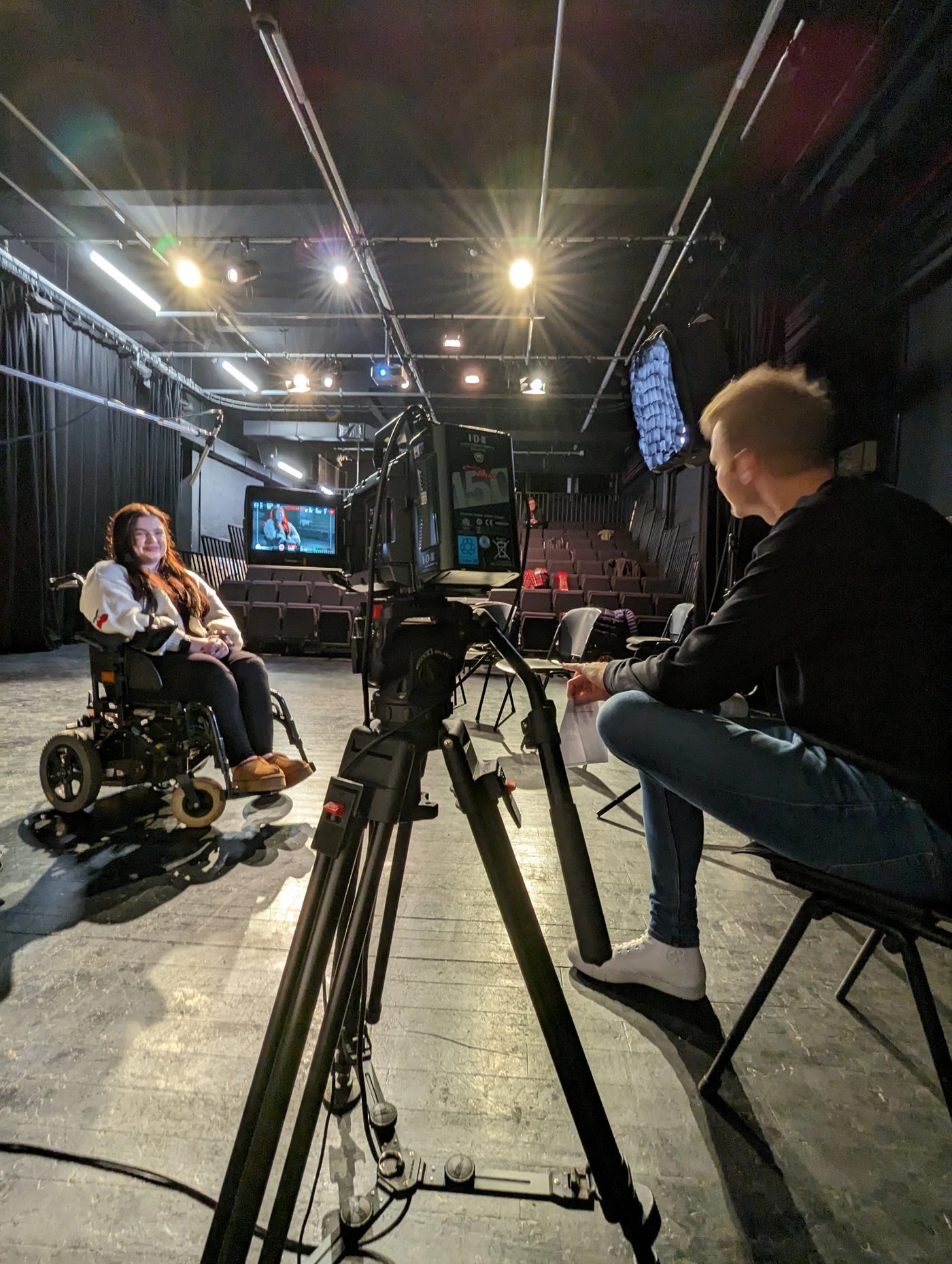Interviewing a subject on the Hoya MiYOSMART campaign set with softboxes and boom microphone